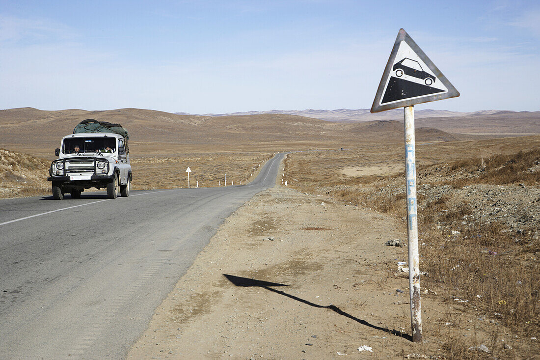 Jeep And Road Sign On Road Between Ulaanbaatar And Karkhorin,Mongolia