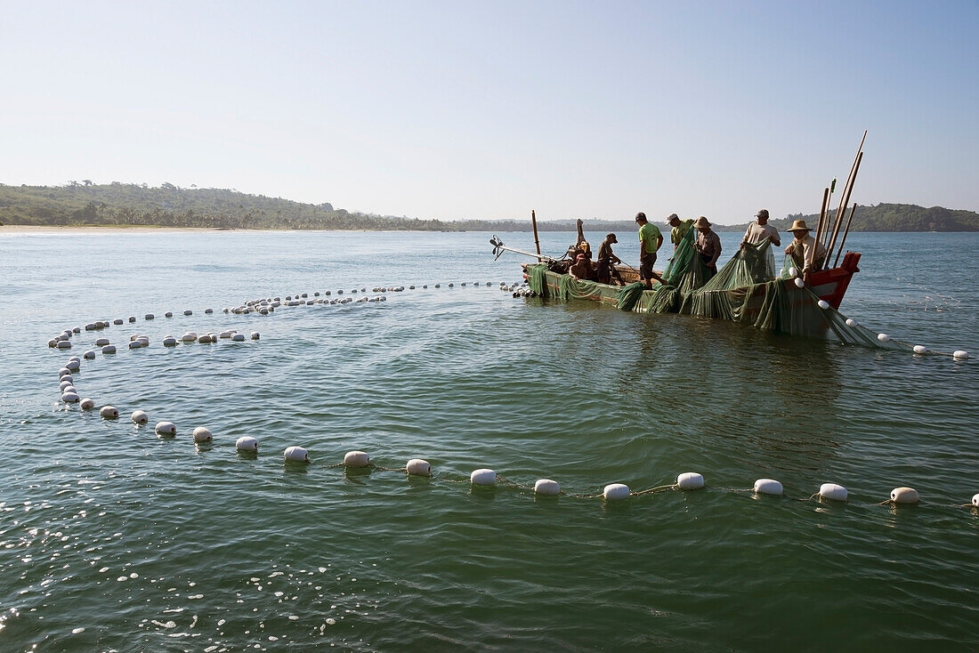 Myanmar (Burma),Irrawaddyi division,Fishermen fishing with large net on boat,Than Pan Ley village