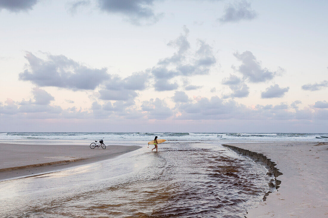 Surfers On Empty Beach,Byron Bay,New South Wales,Australia