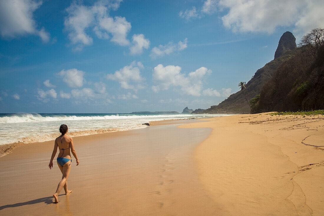 Brazil,Pernambuco,Young woman enjoying view of Morro do Pico from Praia do Boldro,Fernando de Noronha