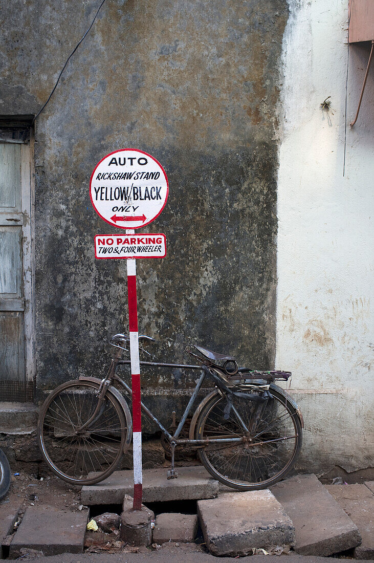 A Bicycle Parked Outside A Building With A Rickshaw Parking Sign,Goa,India