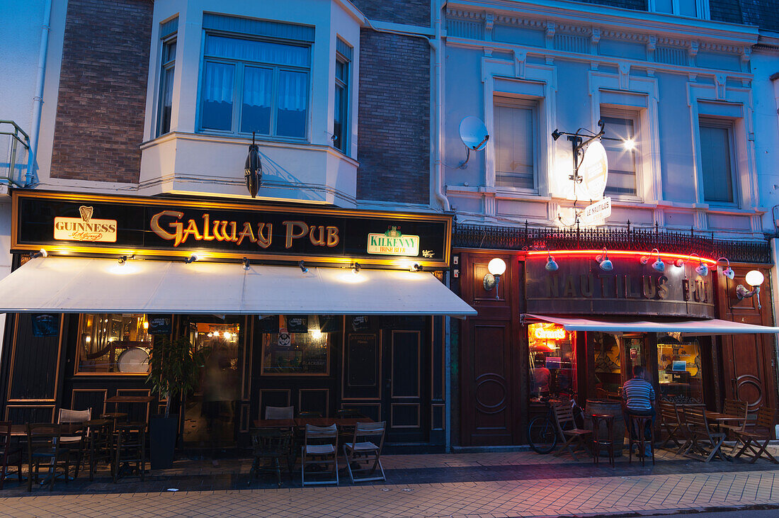 Patrons In Pubs Illuminated At Dusk,Calais,France