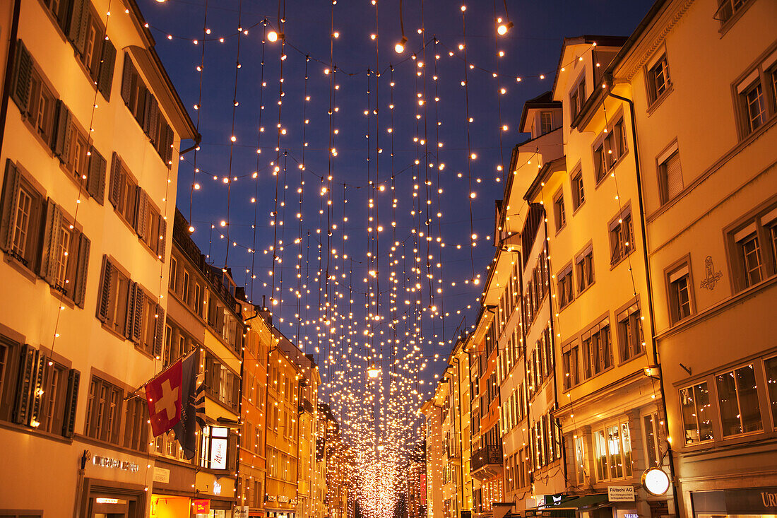 Kleine weiße Lichter aufgereiht über einer Straße zur Weihnachtszeit, Stadt Zürich, Zürich, Schweiz