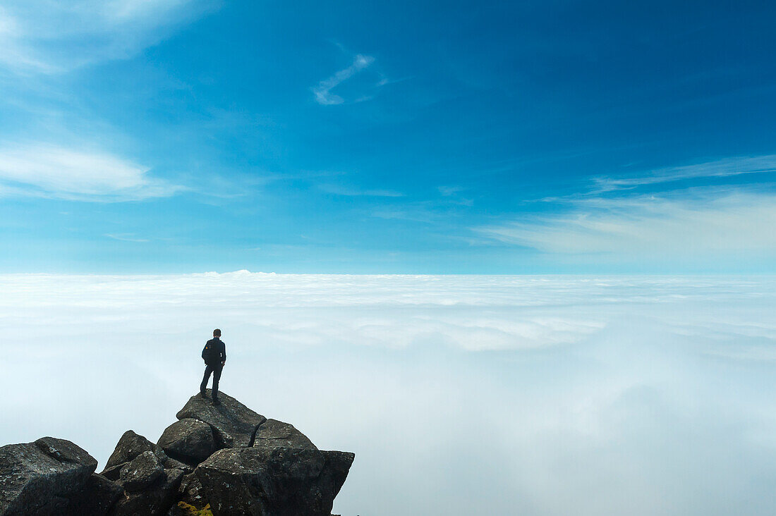 A Hiker Admiring The View From The Top Of Sgurr Nan Eag,One Of The Peaks In The Black Cuillin,Isle Of Skye,Scotland