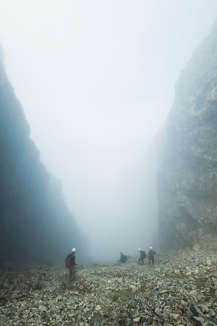 Walkers Descending The Great Stone Chute In The Mist,From Near The Top Of Sgurr Alasdair,Black Cuillin,Isle Of Skye,Scotland