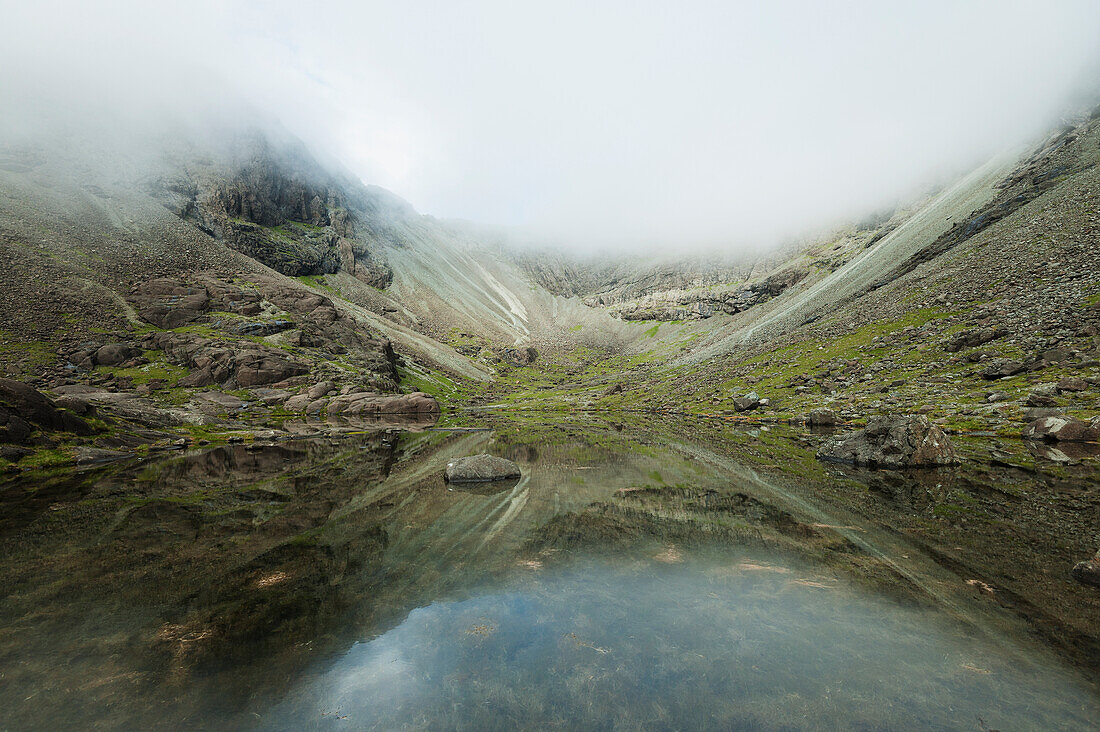 Reflections In Perfectly Still Small Lake Below Sgurr Dearg And Sgurr Alasdair In The Black Cuillin,Isle Of Skye,Scotland