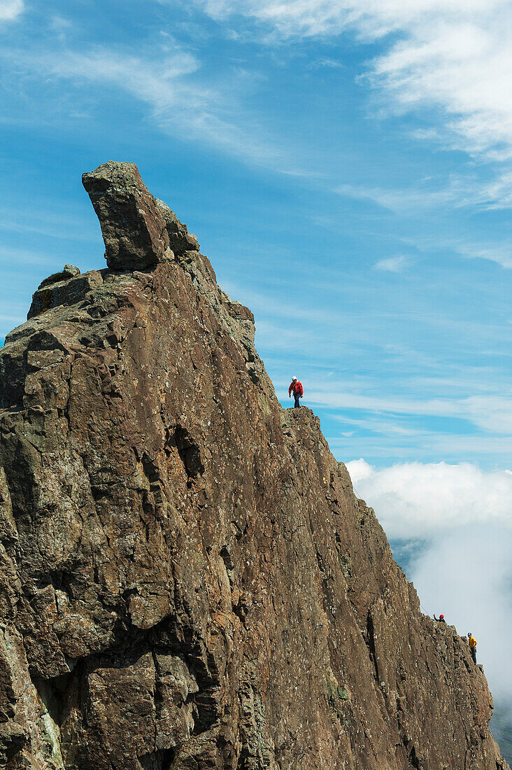 Man Ascending The Inaccessible Pinnacle At The Summit Of Sgurr Dearg,Isle Of Skye,Scotland