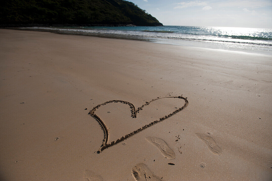 Heart is drawn in the beach sand on Floreana Island in Galapagos Islands National Park,Floreana Island,Galapagos Islands,Ecuador