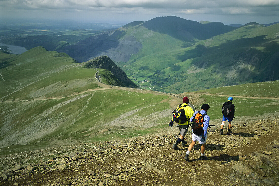 Hikers on a trail high atop Mount Snowdon,Wales