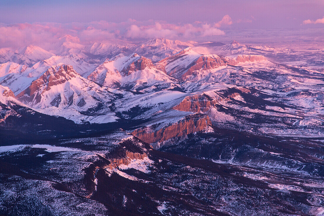 Pink light cast on the snow-covered Front Range of the Rocky Mountains in Montana,USA,Montana,United States of America
