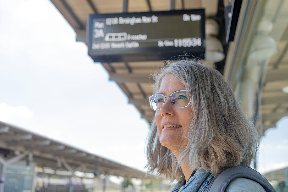 Mature woman waiting at a train station,United Kingdom