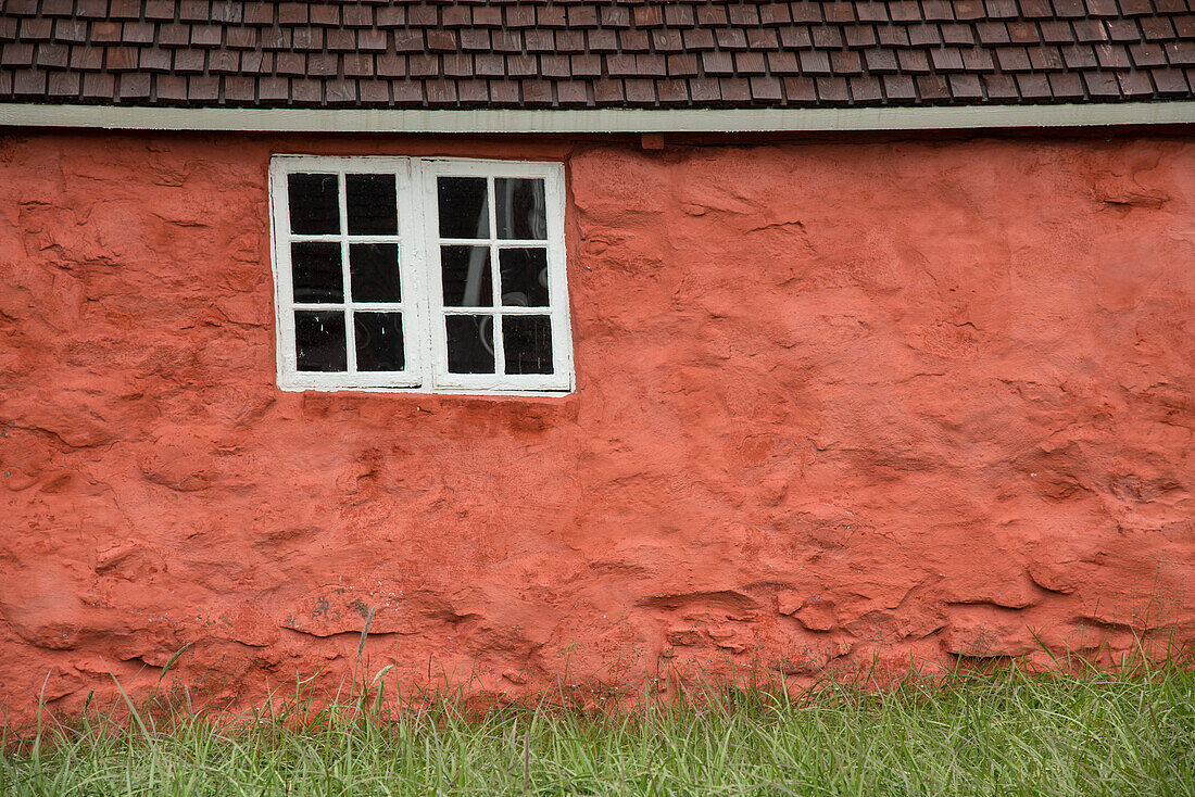 Old wooden framed window in a red stone walled historic home at the Sisimiut Museum,Sisimiut,Greenland