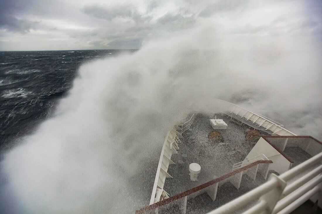 Waves crash against a cruise ship maneuvering through the Drake Passage,Antarctica