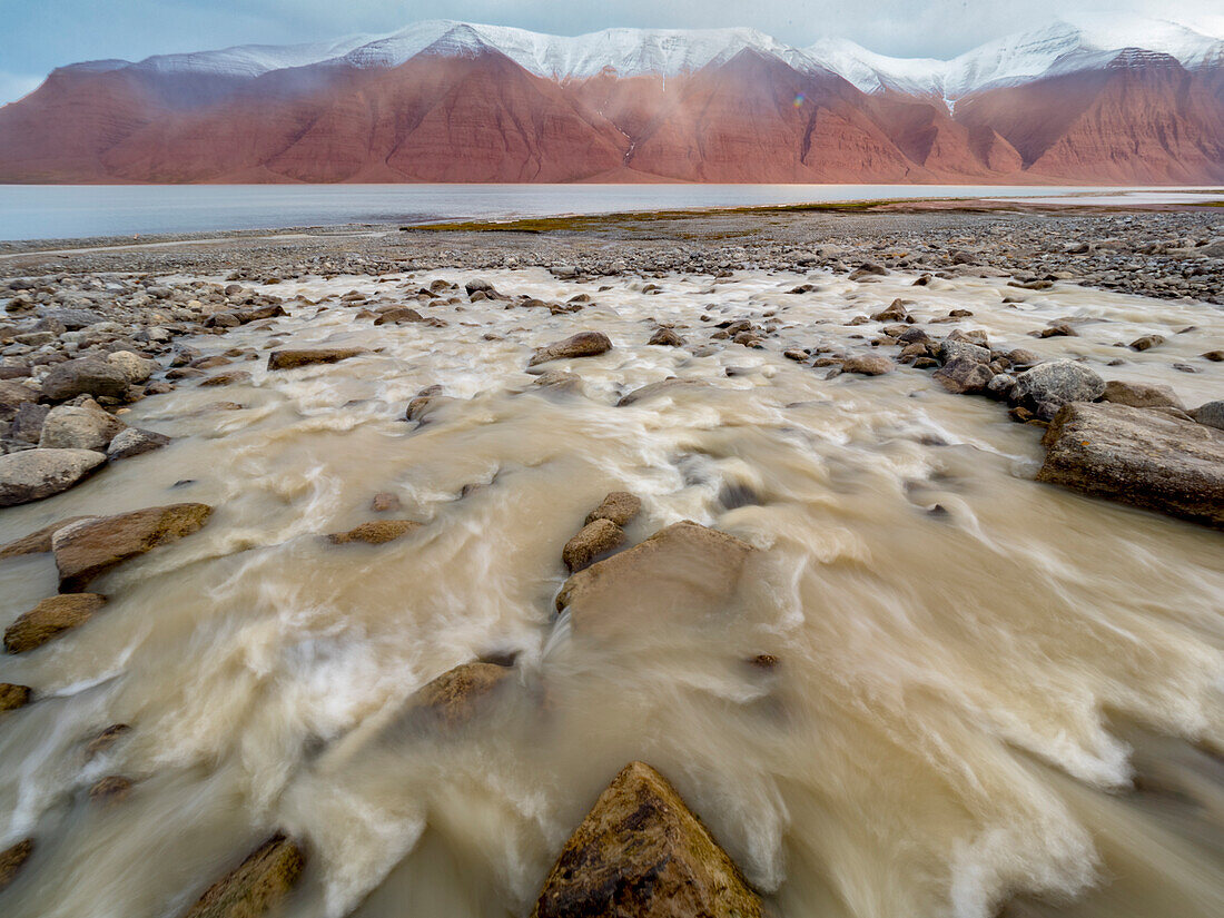 Runoff from an elevated glacier makes its way down to the sea,Spitsbergen,Friesland,Svalbard,Norway