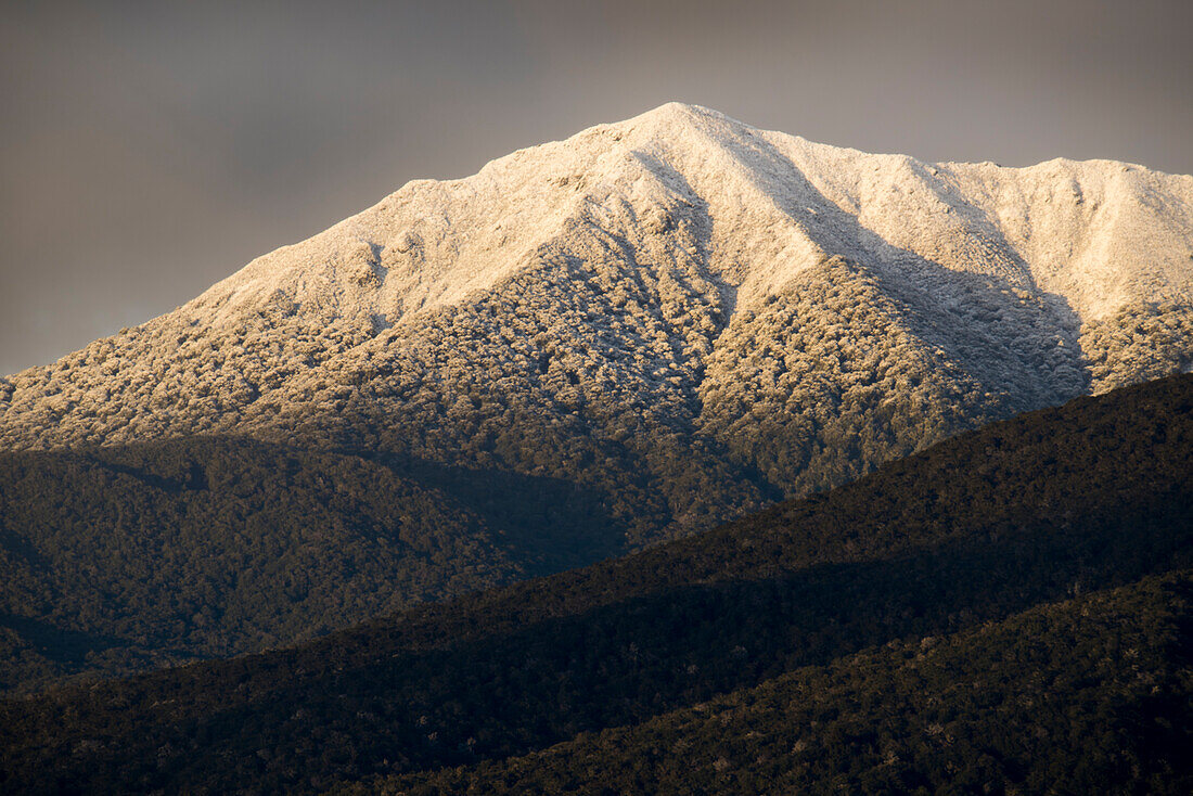 New snow at sunrise on the west side of Lake Te Anau,part of the Keppler Mountains in Fiordland National Park,South Island,New Zealand