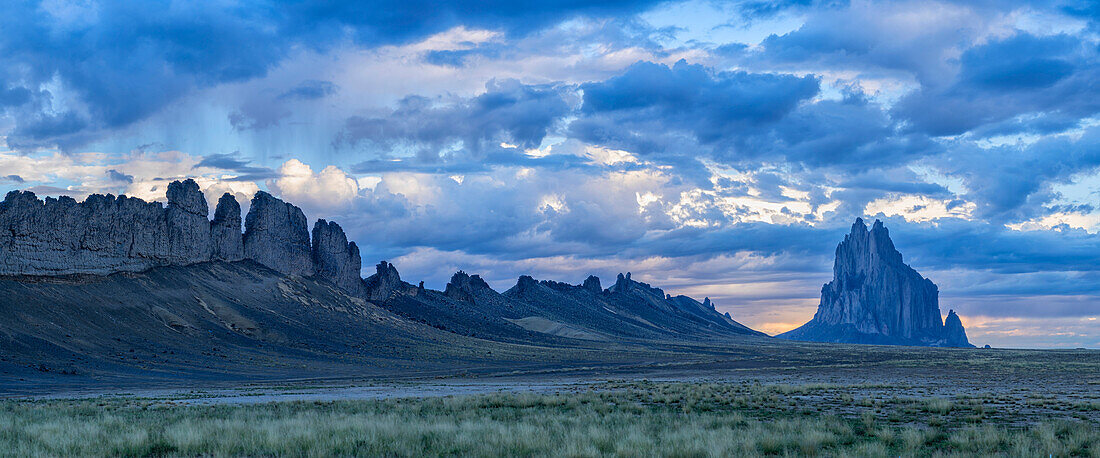 Dramatic storm clouds clear above the rocky ridge and formation of the iconic Shiprock Peak monolith,Shiprock,New Mexico,United States of America