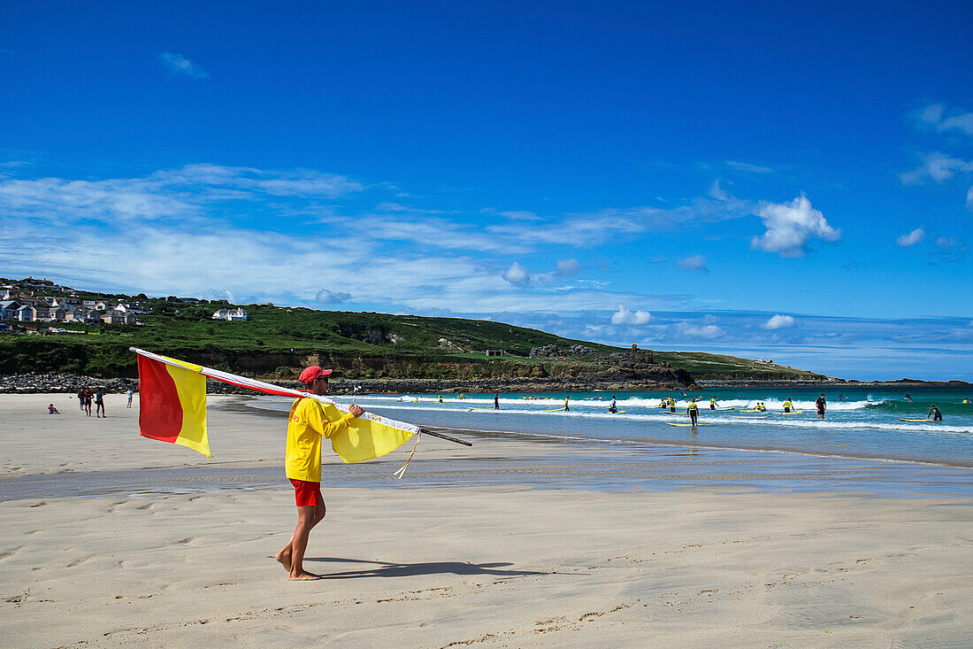 Lifeguard and surfers,St. Ives Beach,Cornwall,England