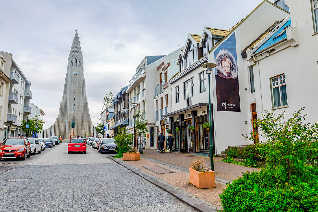 Eine der touristischen Einkaufsstraßen in Reykjavik mit Blick auf die Hallgrimskirkja-Kirche in der Ferne, Reykjavik, Island