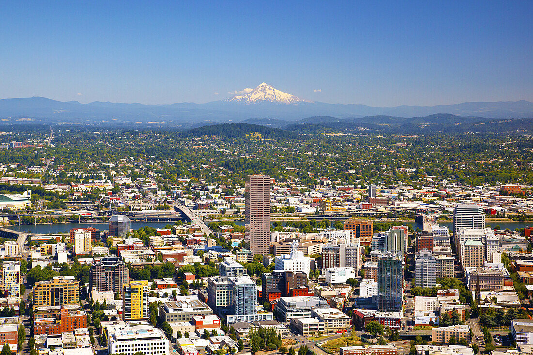 Cityscape of Portland,Oregon with the Willamette River and a view of Mount Hood and the Cascade Range in the distance,Portland,Oregon,United States of America