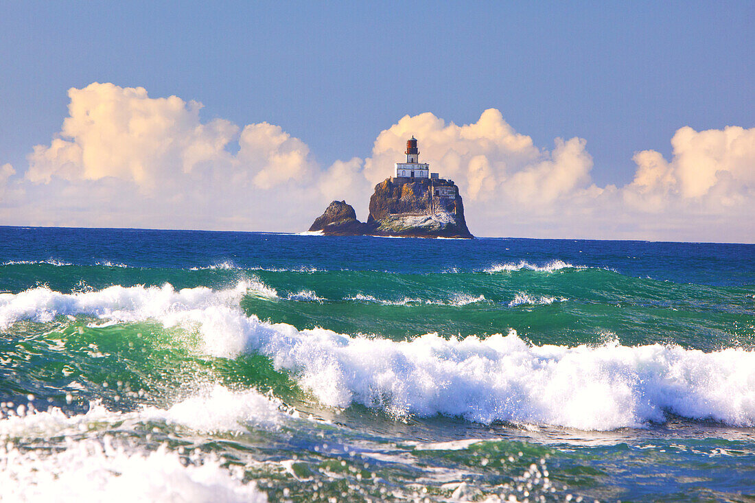 Tillamook Rock Light,a deactivated lighthouse off the coast of Oregon,and waves of the surf rolling into shore,Oregon,United States of America
