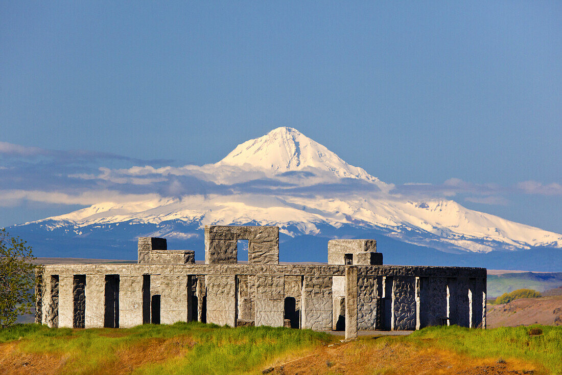 Replica of Stonehenge at the Maryhill Museum of Art in the foreground with a snow-capped Mount Hood in the background,Washington,United States of America