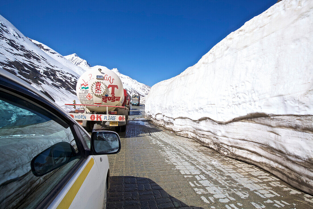 Convoy of trucks on the Srinagar to Leh highway heading through glacier towards Kashmir from Ladakh,Jammu and Kashmir,Shey,Ladakh,India