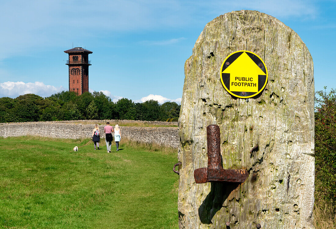 People walking at Cleadon Hills with the water tower in the background,South Shields,Tyne and Wear,England