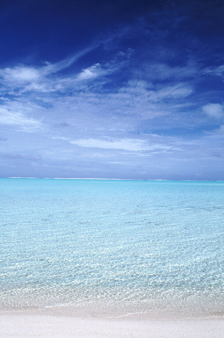 Clear turquoise ocean water leading out from a white sand beach in the South Pacific,Cook Islands