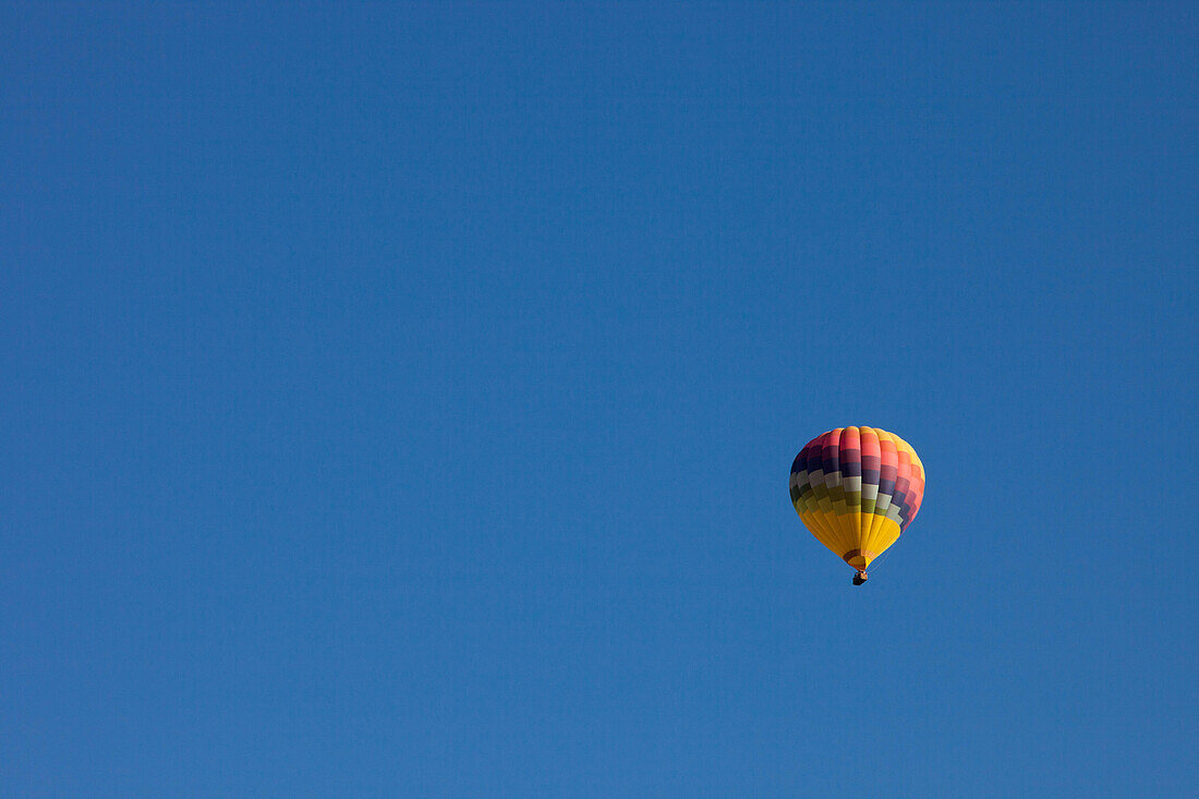 A hot air balloon flying in a clear,blue sky.,Winters,California