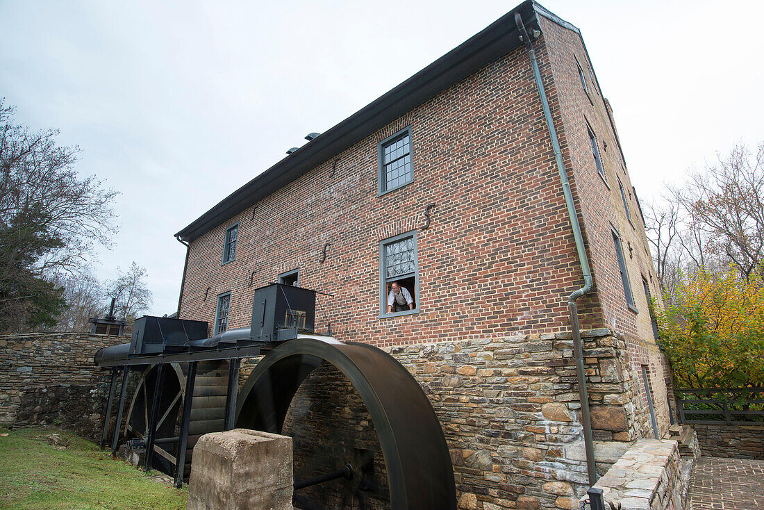The miller looks on as the wheels turn the water at the Aldie Mill in Loudoun County,Virginia.