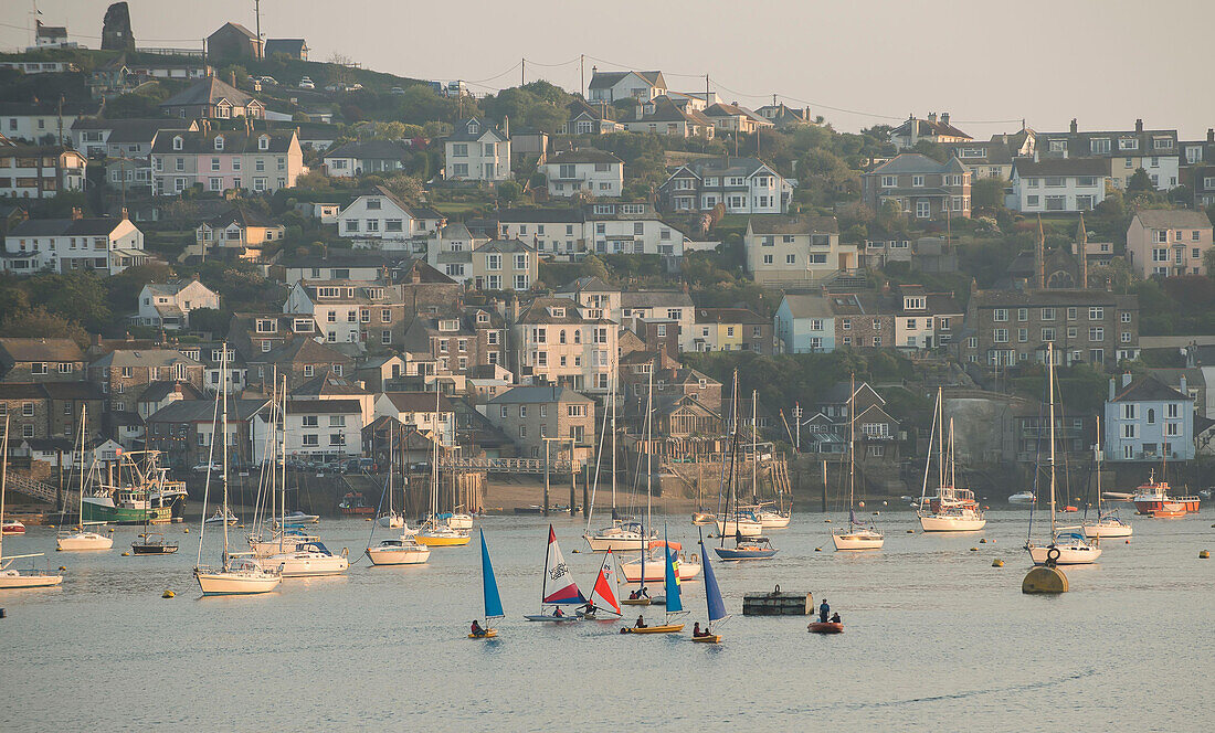 Small colorful sailboats are sailed in the harbor at the fishing village of Polruan,Cornwall,England.