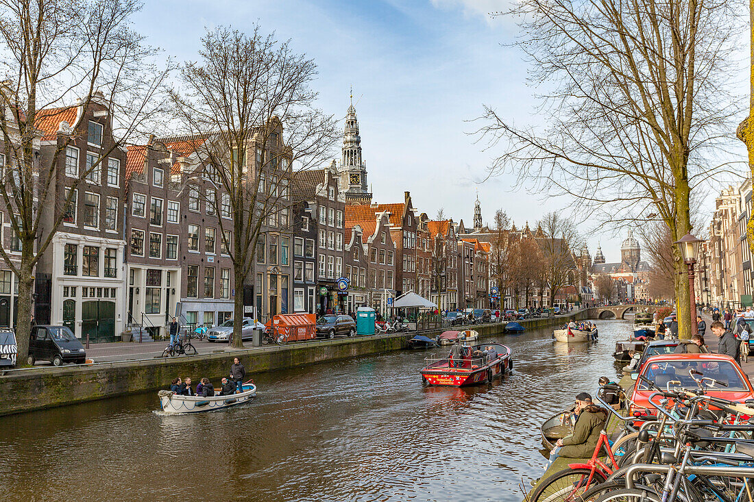 Boats on the canal,Oudezijds Voorburgwal,with bell tower of the Oude Kerk (Old Church) in the background,Amsterdam,Amsterdam,North Holland,Netherlands