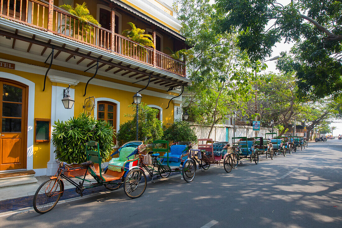 Bicycle rickshaws outside French colonial era Palais de Mahe boutique hotel in Pondicherry,India,Puducherry,Tamil Nadu,India