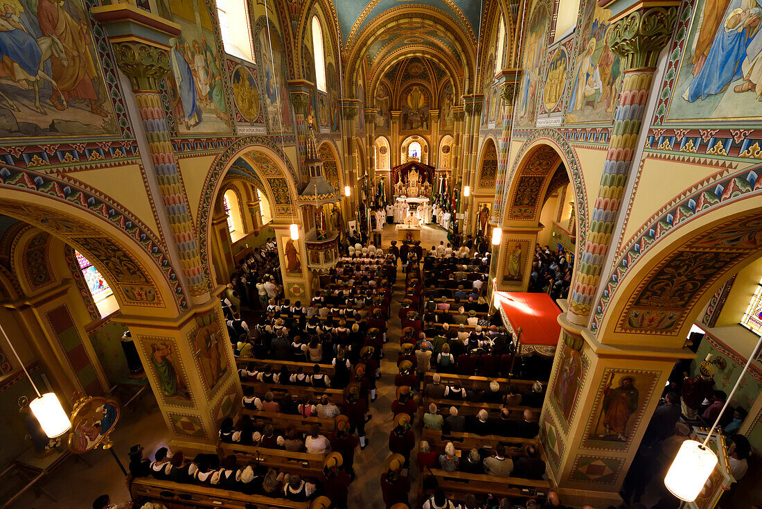 Inside the Mary Immaculate parish church in Weerberg village,local people celebrate Herz-Jesu.,Austria.