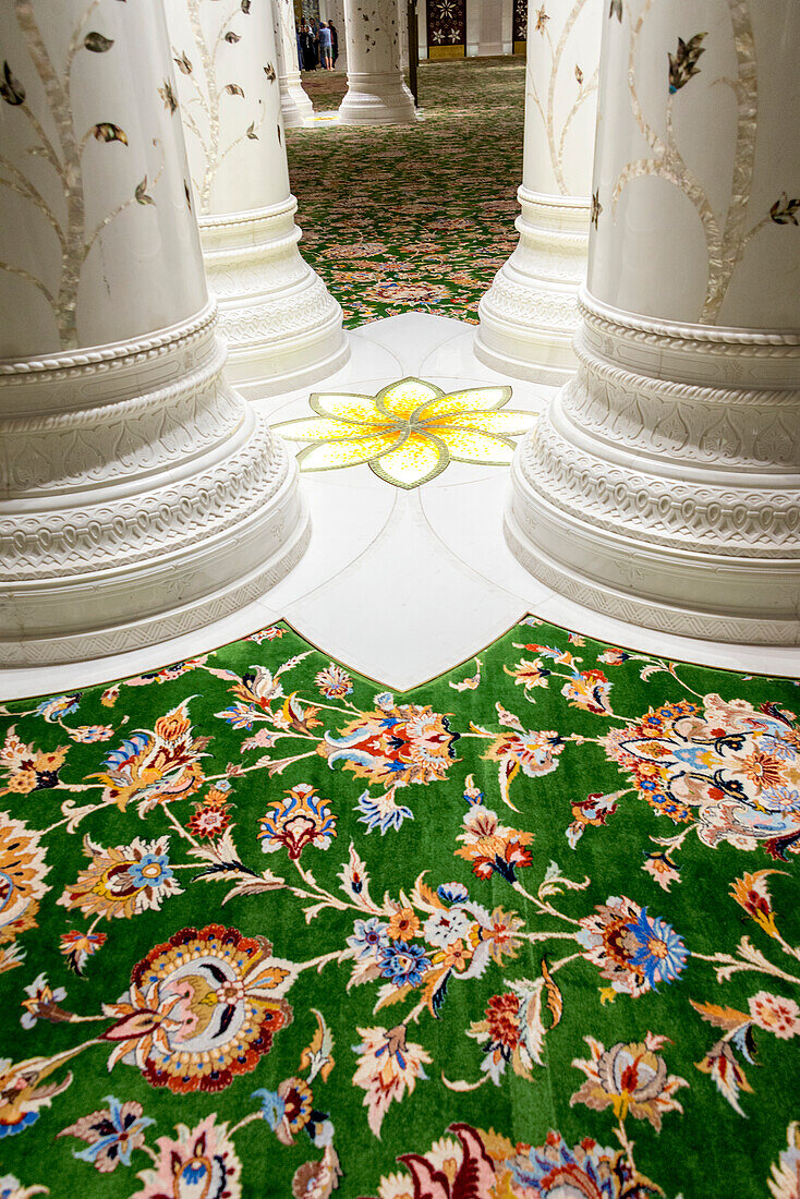 An interior view of the ornate flooring in the Grand Mosque in Abu Dhabi City,UAE. The columns are also adorned with ornate inlay patterns in the marble,Abu Dhabi,United Arab Emirates
