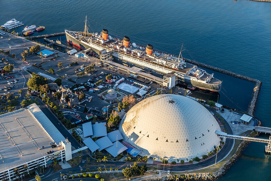 RMS Queen Mary,now a hotel ship and tourist attraction at Long Beach,California.  Dome is former home of Howard Hughes' Spruce Goose,Long Beach,California,United States of America