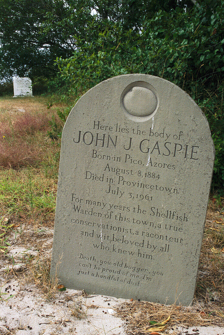A tombstone with epitaph and relief sculpture of a clam.,Provincetown,Cape Cod,Massachusetts.