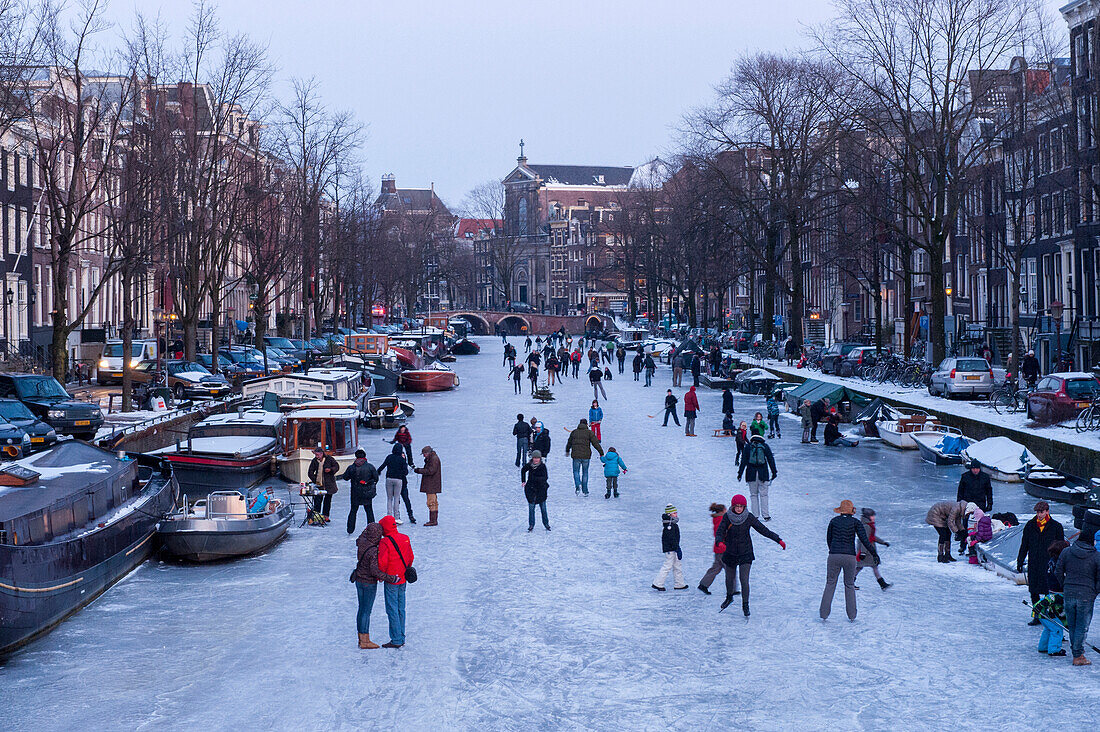 Numerous people ice skating on the canals,Amsterdam,Netherlands