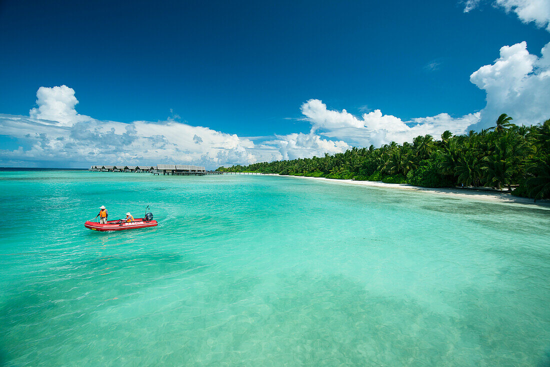 Two people in an inflatable boat at a beach resort at the Maldives,Republic of the Maldives