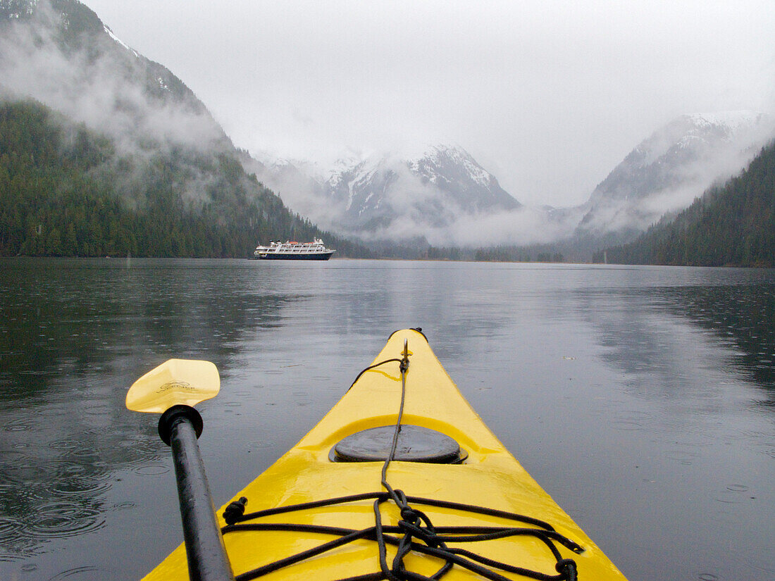 Kayaking in Khutze Inlet near a cruise ship in Khutze Inlet,BC,Canada,British Columbia,Canada