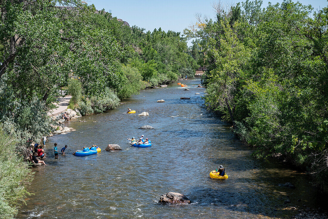 Tubers enjoying a cool float down Clear Creek in Golden,Colorado,USA,Golden,Colorado,United States of America