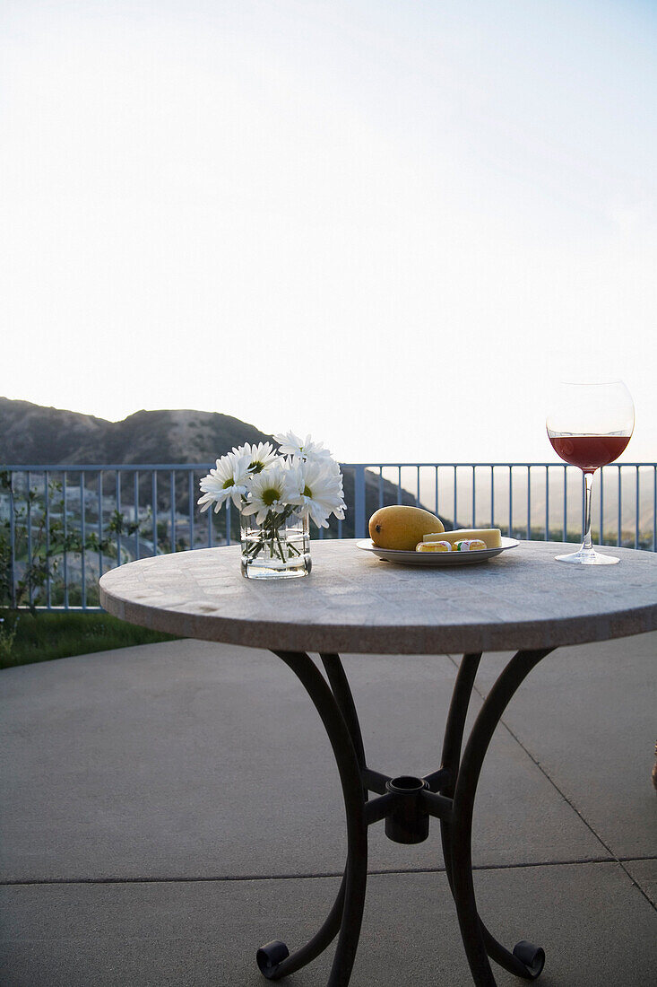 Table with Flowers,Fruit and Wine on Patio