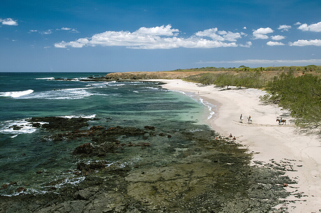 Aerial view of surf and beach with horseback riders,Costa Rica,Costa Rica