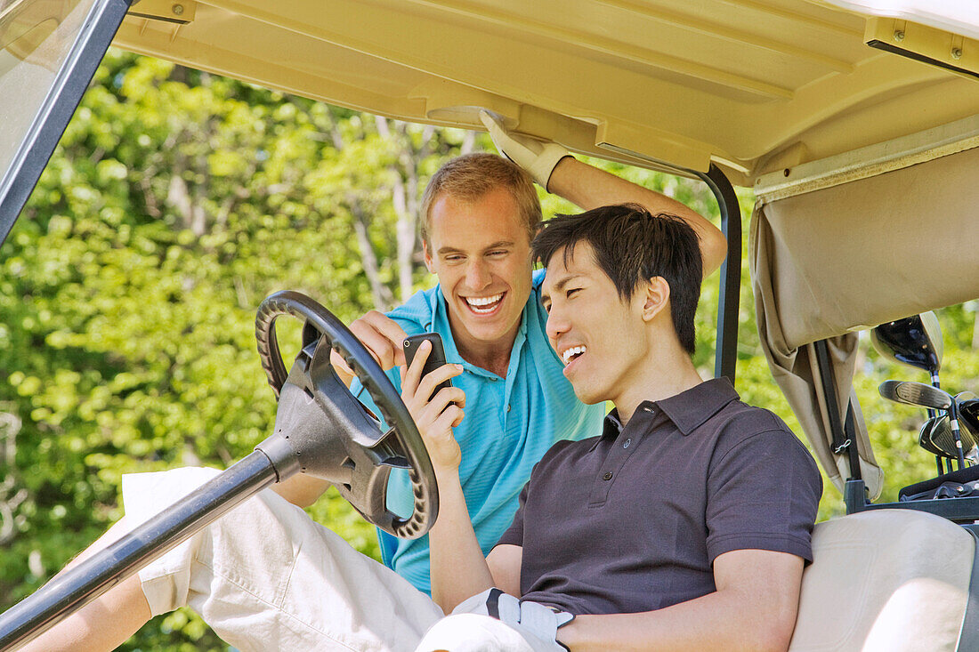 Men in Golf Cart Reading Text Message