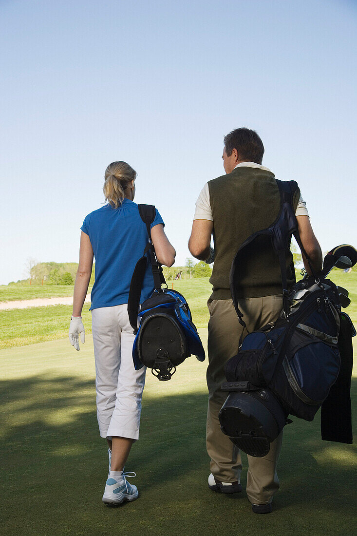 Couple Walking on Golf Course