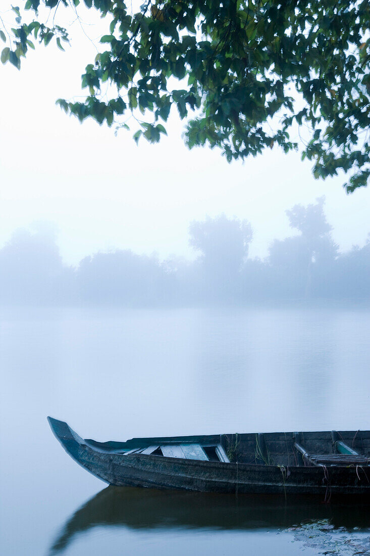 Canoe in Morning Mist at Sras Srang,Angkor,Cambodia