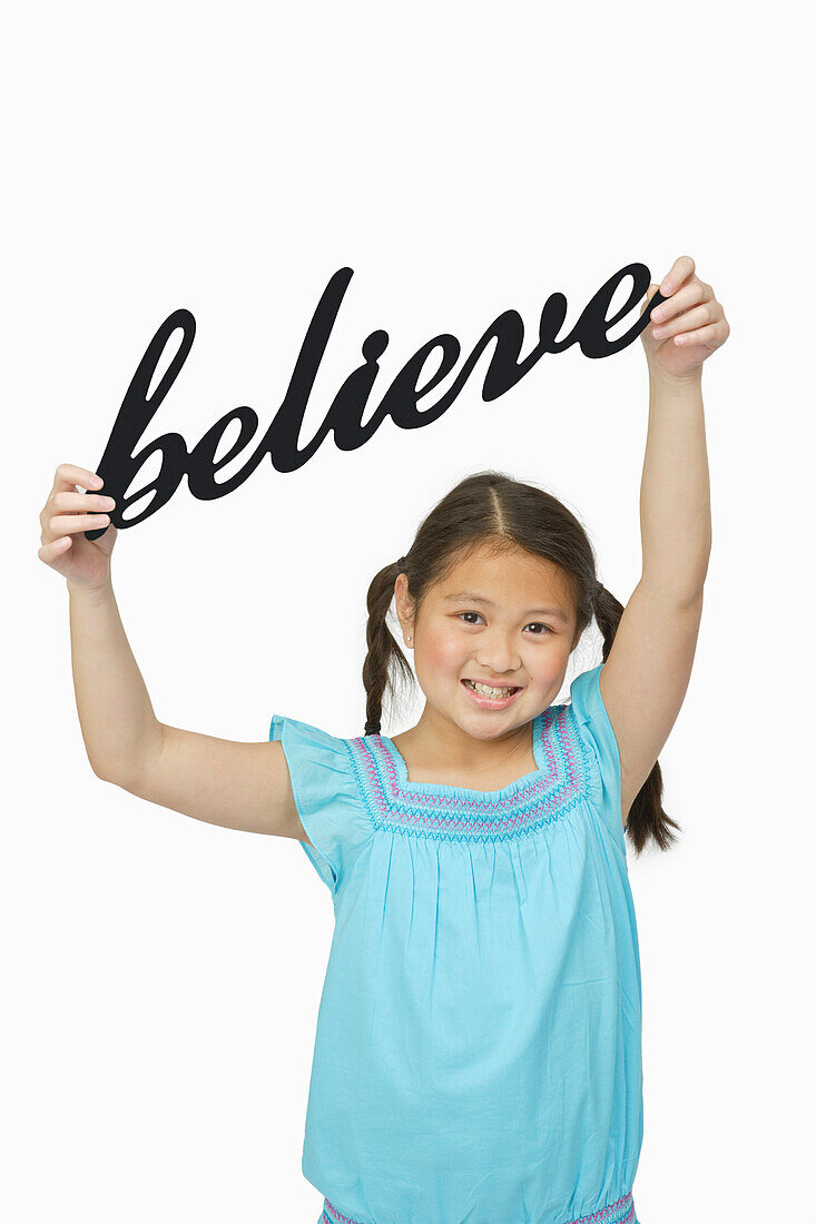 Girl Holding Believe Sign