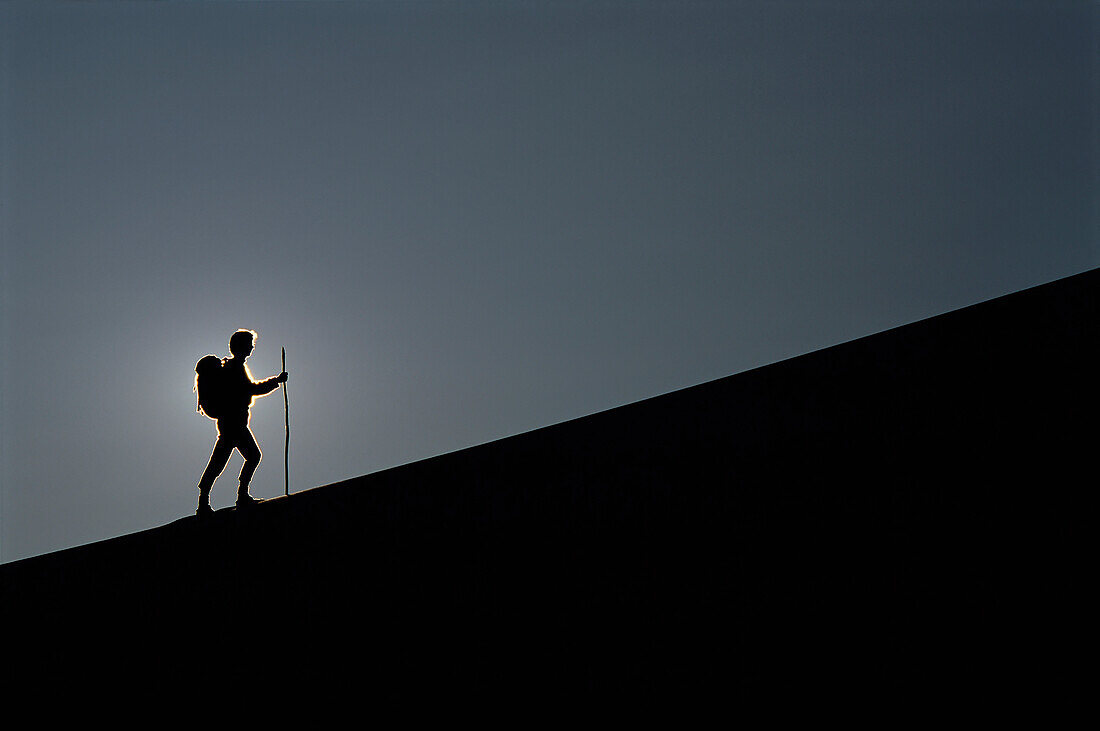 Silhouette of Person Hiking Mesquite Dunes,Death Valley California,USA