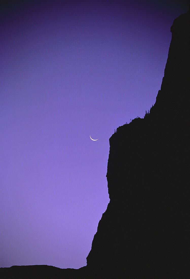 Silhouette of Cliff and Moon Banff National Park,Rocky Mountains,Alberta,Canada