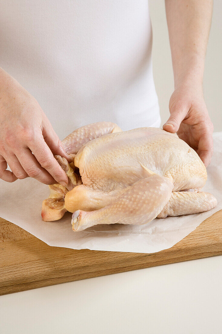 Woman Preparing Chicken for Roasting